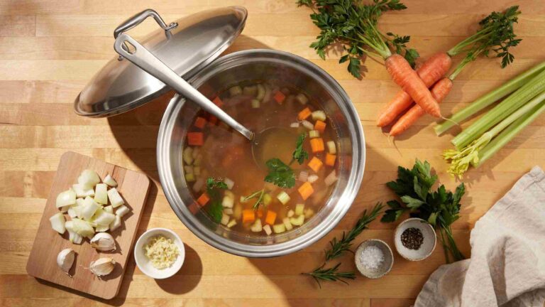 Stainless steel stock pot filled with vegetables for everyday cooking.